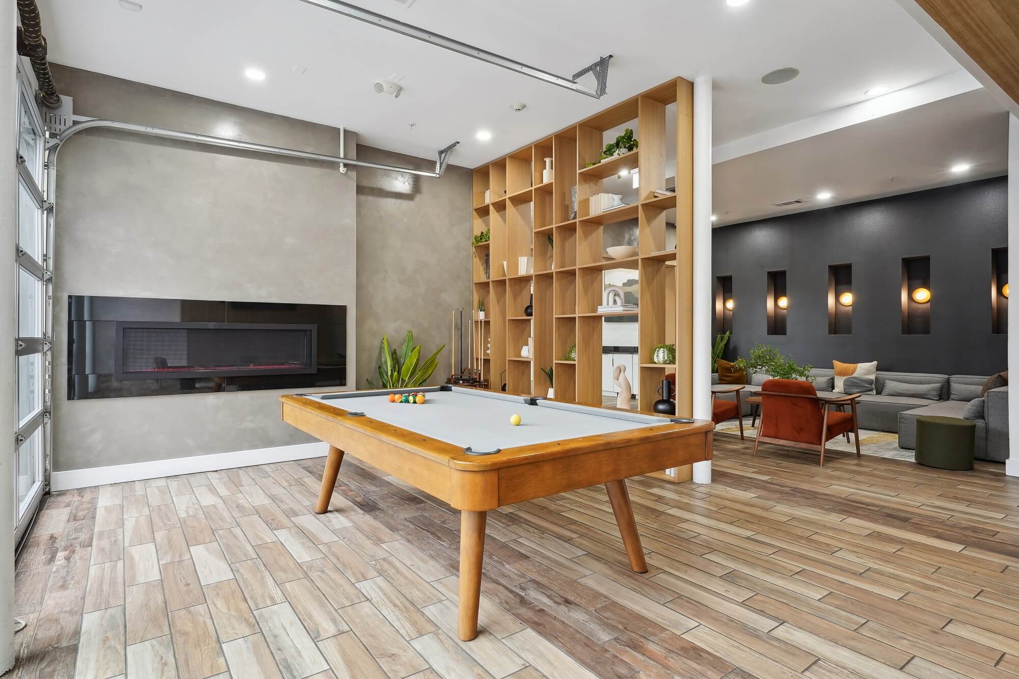Clubhouse game room with billiards and fire place