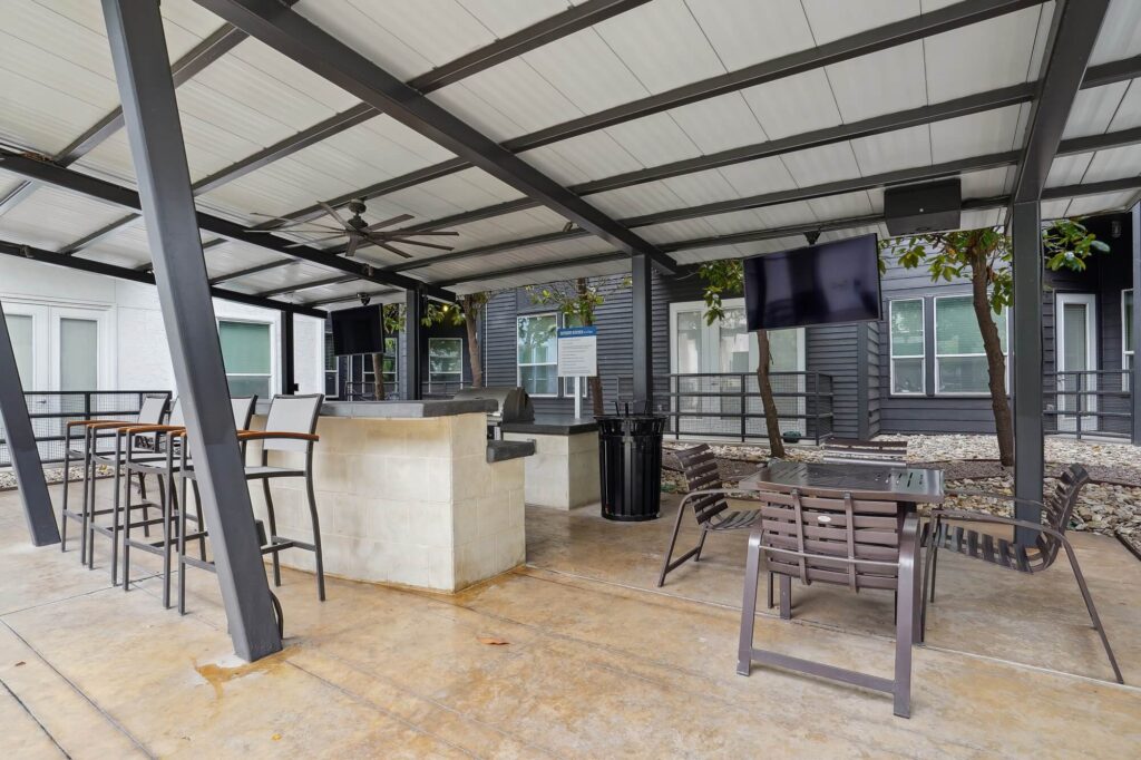 Covered patio with grills and TVs