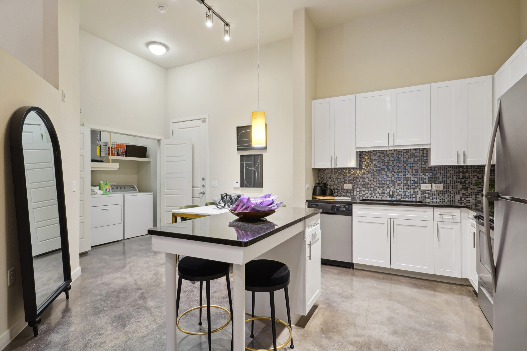 Kitchen with stainless steel appliances, granite counters, and tile backsplash