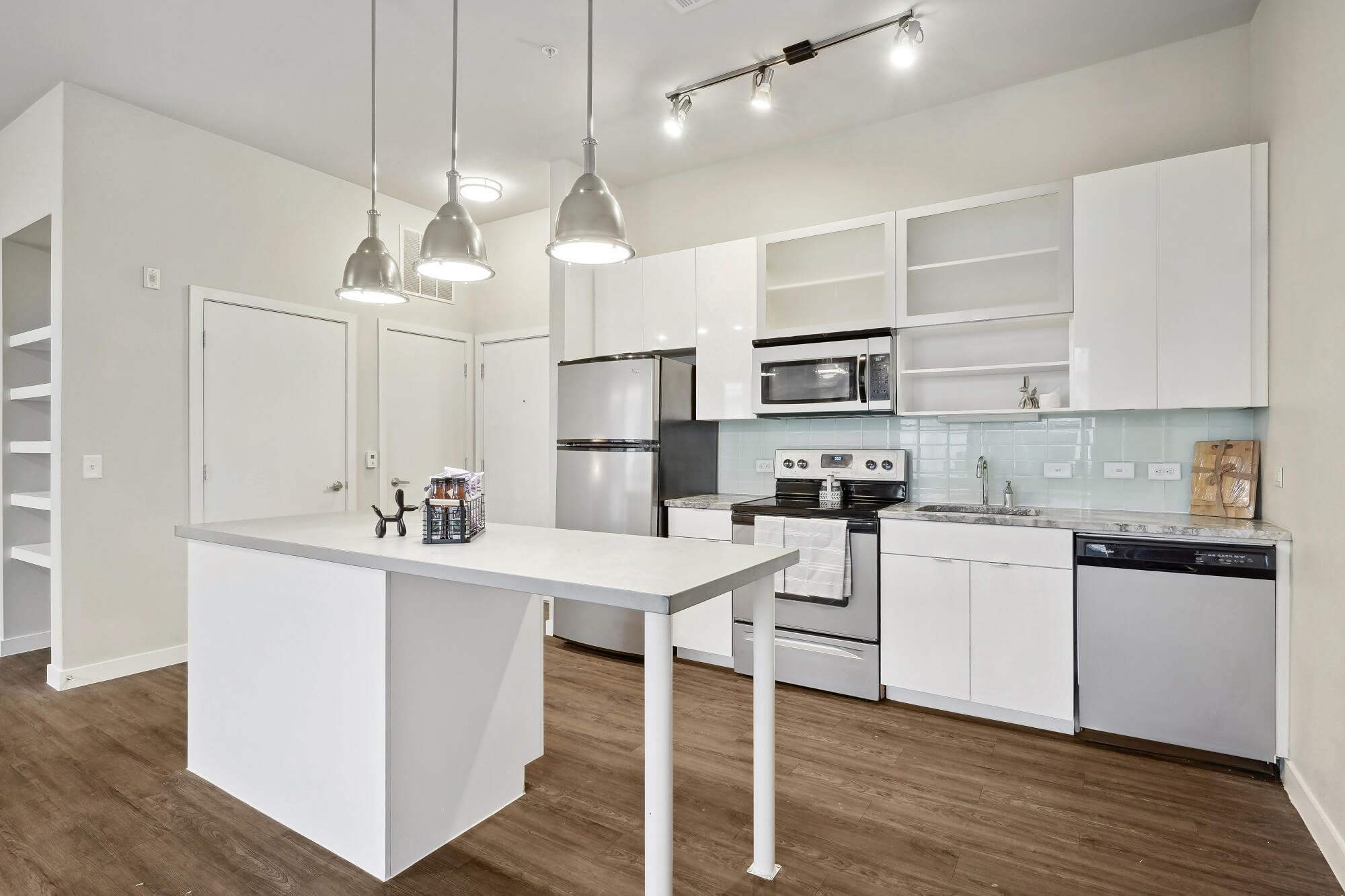 Kitchen with stainless steel appliances and tile backsplash