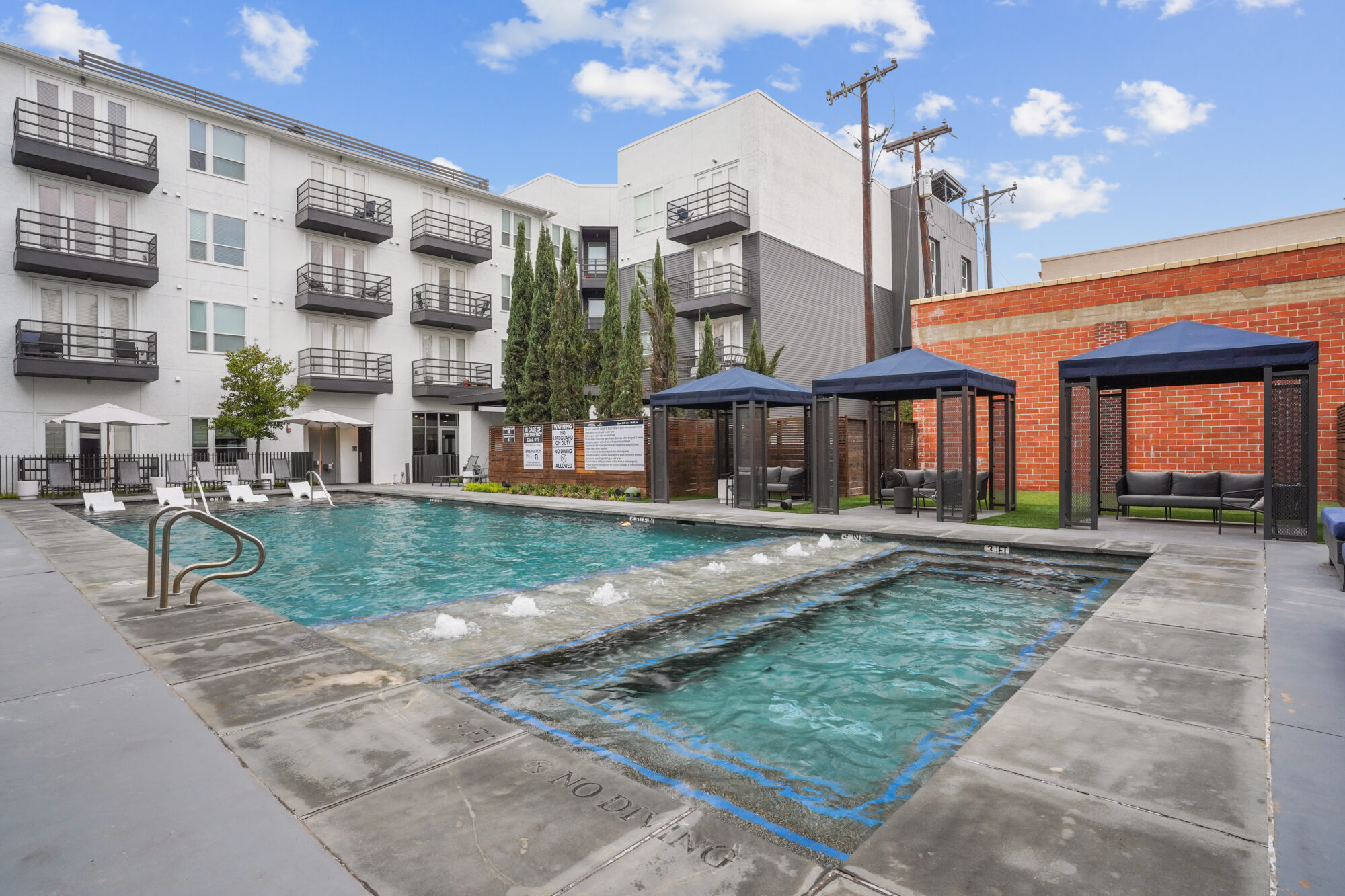 Pool with deck seating and cabanas